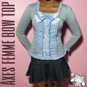 Axes femme bow top it has buttons, lace, and frills.